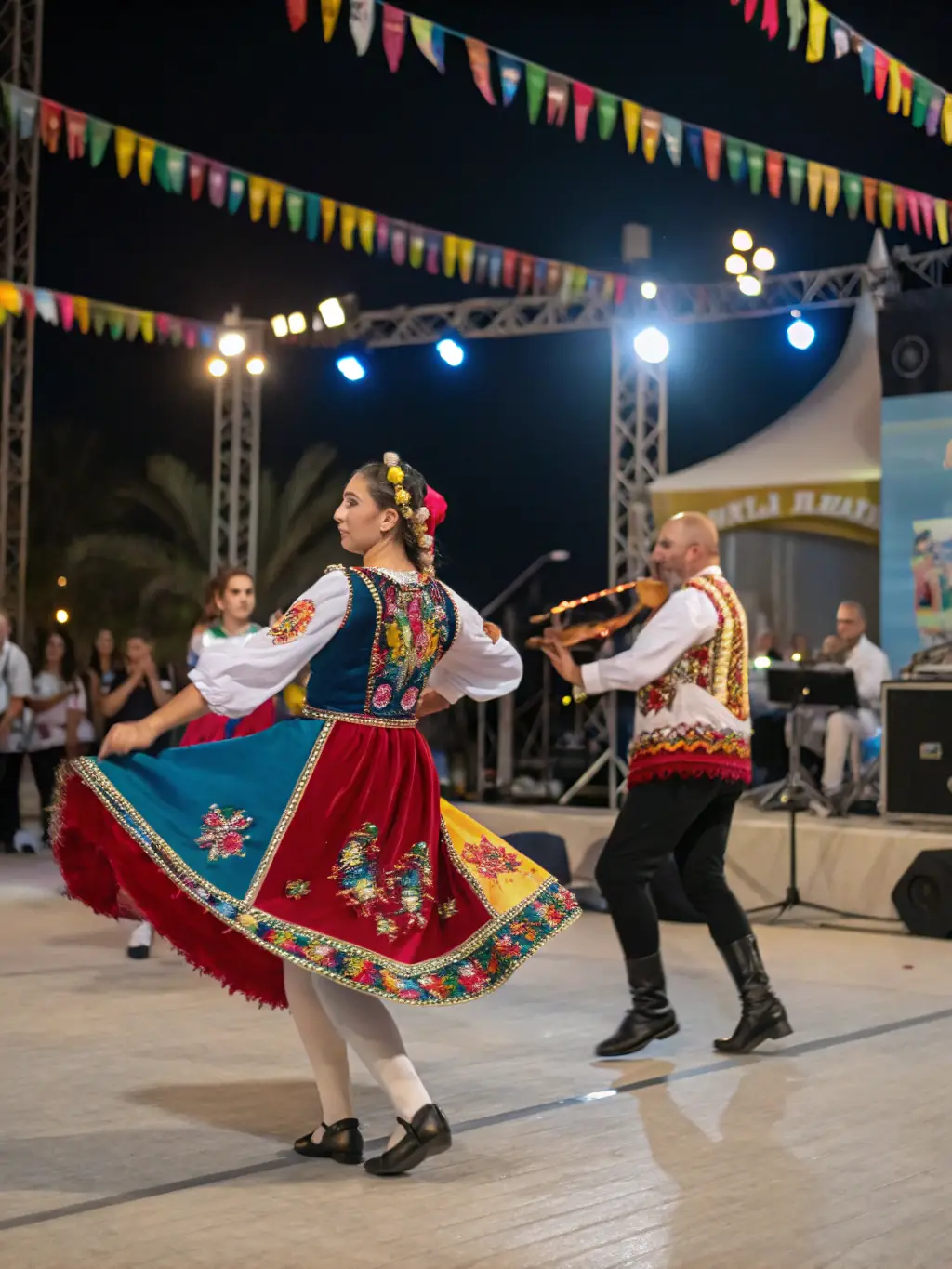 A lively traditional dance performance during a local festival, with dancers in traditional costumes showcasing the region's cultural heritage, supported by TOUTAZIMUT.